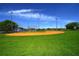 Community baseball field featuring grassy outfield and clay infield with tall lighting at 824 62Nd Ne Ave, St Petersburg, FL 33702