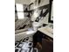 Modern bathroom with tile walls, patterned floors, and vanity at 824 62Nd Ne Ave, St Petersburg, FL 33702