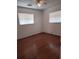 Bedroom with wood floors, ceiling fan, and natural light at 824 62Nd Ne Ave, St Petersburg, FL 33702