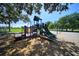 Community playground with multiple slides and playground equipment on a wood chip base at 824 62Nd Ne Ave, St Petersburg, FL 33702