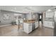 Open kitchen features granite countertops, stainless steel appliances, and an island with seating at 2376 Hanover Dr, Dunedin, FL 34698