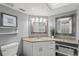 Clean bathroom with granite countertop and a large mirror at 2376 Hanover Dr, Dunedin, FL 34698