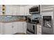 Updated kitchen with stainless steel appliances and granite countertops at 2376 Hanover Dr, Dunedin, FL 34698