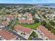 Aerial view of condo community with pool and lush landscaping at 2376 Hanover Dr, Dunedin, FL 34698
