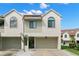 Two-story townhome with attached garage and landscaping at 2376 Hanover Dr, Dunedin, FL 34698