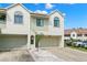 Two-story condo with attached garage and attractive landscaping at 2376 Hanover Dr, Dunedin, FL 34698