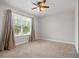 Bright bedroom with large window, ceiling fan, and neutral decor at 2503 Arch Ave # 139W, Oldsmar, FL 34677