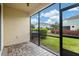 Private screened porch with paver patio and view of backyard at 2503 Arch Ave # 139W, Oldsmar, FL 34677