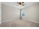 Spacious bedroom with neutral walls, ceiling fan, and carpeted floor at 2503 Arch Ave # 139W, Oldsmar, FL 34677