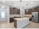 Modern kitchen with dark cabinets, granite countertops, and stainless steel appliances at 2503 Arch Ave # 139W, Oldsmar, FL 34677