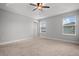 Spacious bedroom with ceiling fan and neutral carpeting at 2503 Arch Ave # 139W, Oldsmar, FL 34677