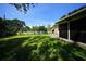 Large backyard with grassy area and fire pit at 824 62Nd Ne Ave, St Petersburg, FL 33702
