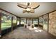 Bright screened porch with stone fireplace and ceiling fan at 824 62Nd Ne Ave, St Petersburg, FL 33702