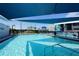Community pool with shade structures and nearby playground at 824 62Nd Ne Ave, St Petersburg, FL 33702