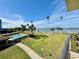 Stunning aerial view of waterfront property with pool and lush landscaping at 100 Oakmont Ln # 301, Belleair, FL 33756