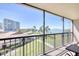 Balcony view showcases lush greenery, a swimming pool, and a water view for relaxation and enjoyment at 100 Oakmont Ln # 301, Belleair, FL 33756