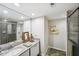 Bright bathroom featuring a granite countertop, large mirror, decorative accents, and tiled walk-in shower at 100 Oakmont Ln # 301, Belleair, FL 33756