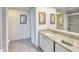 Bathroom features a granite countertop vanity, neutral paint, and a combination shower and tub at 100 Oakmont Ln # 301, Belleair, FL 33756