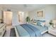 Calm bedroom featuring coordinated furnishings, a large window, and ample closet space for storage and organization at 100 Oakmont Ln # 301, Belleair, FL 33756