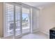 Bedroom balcony overlooking a pool area, showcasing shuttered glass doors at 100 Oakmont Ln # 301, Belleair, FL 33756