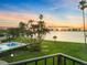Breathtaking sunset view overlooking the pool, bay, and city skyline from the condominium's outdoor space at 100 Oakmont Ln # 301, Belleair, FL 33756