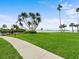 Manicured grounds offering beautiful water views, walking paths, and mature palm trees at 100 Oakmont Ln # 301, Belleair, FL 33756