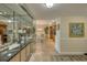 Hallway with wall-to-wall mirrors, tiled floors, and bright dining area at 100 Oakmont Ln # 301, Belleair, FL 33756