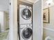Convenient laundry closet with stacked washer and dryer units, maximizing space in the home at 100 Oakmont Ln # 301, Belleair, FL 33756