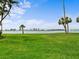 Expansive green lawn with scenic views of the water and cityscape in the distance at 100 Oakmont Ln # 301, Belleair, FL 33756
