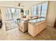 Bright living room with water views, comfy seating, and large windows at 100 Oakmont Ln # 301, Belleair, FL 33756