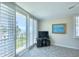 Living room with balcony access, windows featuring shuttered blinds, and waterfront view at 100 Oakmont Ln # 301, Belleair, FL 33756