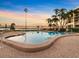 Gorgeous pool with palm trees and a colorful sunset at 100 Oakmont Ln # 301, Belleair, FL 33756