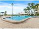 Serene view of pool and waterfront dotted with palm trees, bay and condos at 100 Oakmont Ln # 301, Belleair, FL 33756