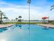 Enjoy the community swimming pool with seating and views of the water, perfect for relaxation at 100 Oakmont Ln # 301, Belleair, FL 33756