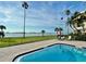 Stunning water view from the pool area with clear blue water and palm trees, perfect for relaxation at 100 Oakmont Ln # 301, Belleair, FL 33756