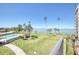 A ground level view of a waterway, pool, palms trees, and skyline at 100 Oakmont Ln # 301, Belleair, FL 33756