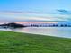 Picturesque waterfront with a walking path along the water at dusk at 100 Oakmont Ln # 301, Belleair, FL 33756