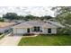 An elevated view of a cozy home featuring an attached garage, landscaping, and a welcoming facade at 1172 Chelsea Ln, Holiday, FL 34691