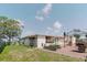 Spacious backyard featuring a patio area, lush greenery, and mature tree at 1172 Chelsea Ln, Holiday, FL 34691