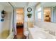 Bathroom featuring a tub and shower, a toilet, and vanity with a view to bedroom at 1172 Chelsea Ln, Holiday, FL 34691