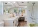 Large bathroom with a double vanity, tile flooring, and a big mirror. It also offers a shower and a bath at 1172 Chelsea Ln, Holiday, FL 34691
