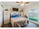 Bedroom with a Murphy bed, built-in storage, and a view to the outdoors. Natural light fills the room at 1172 Chelsea Ln, Holiday, FL 34691