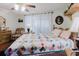 Bedroom featuring a dresser, wood flooring, and a ceiling fan, with a quilt-covered bed offering a cozy and traditional feel at 1172 Chelsea Ln, Holiday, FL 34691