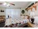 Comfortable bedroom with an upholstered chair, wood flooring, and a ceiling fan, with plenty of natural light at 1172 Chelsea Ln, Holiday, FL 34691
