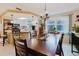 Dining room with wood table, chairs, and view into kitchen with stainless steel appliances at 1172 Chelsea Ln, Holiday, FL 34691
