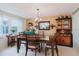 Formal dining room with a rustic wooden table set and decorative accents at 1172 Chelsea Ln, Holiday, FL 34691