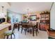 Formal dining room features hardwood table, six chairs, hutch, and chandelier at 1172 Chelsea Ln, Holiday, FL 34691