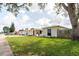 A traditional single-story home showcasing a tidy lawn and easy access to the neighborhood sidewalk at 1172 Chelsea Ln, Holiday, FL 34691