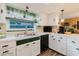 Bright kitchen featuring white cabinets, modern stainless steel appliances, and lots of counter space at 1172 Chelsea Ln, Holiday, FL 34691