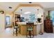 Bright, inviting kitchen with counter seating, stainless steel appliances, and ample natural light, creating a perfect spot to cook at 1172 Chelsea Ln, Holiday, FL 34691